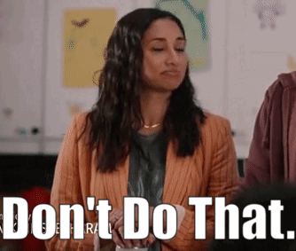 Woman in Orange Jacket Standing Before Do Not Do That Sign