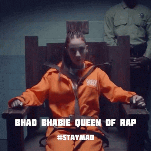 Woman in Orange Jumpsuit Sitting Bhad Bhabie Queen of Rap