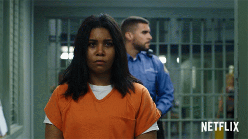 Woman In Orange Uniform Jail Cell Netflix Logo GIF