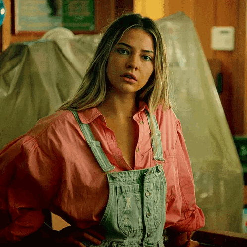 Woman in Overalls and Pink Shirt