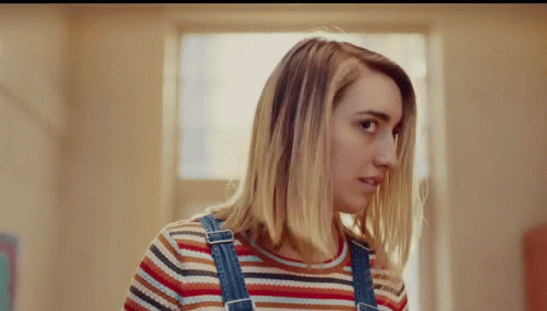Woman in Overalls and Striped Shirt Looking to Side