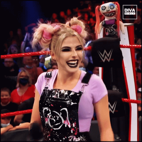 Woman In Overalls In Wrestling Ring With Diva Doll GIF