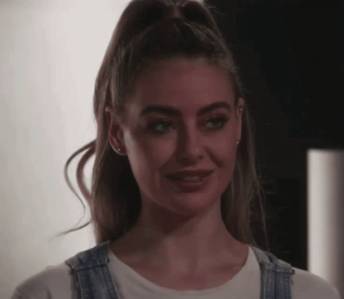 Woman in Overalls Smiling