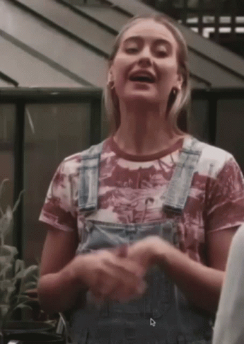 Woman in Overalls With Dinosaur T-Shirt