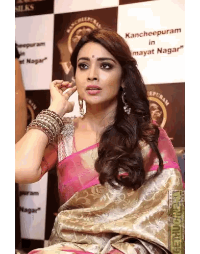 Woman in Pink and Gold Saree Kancheepuram Sign