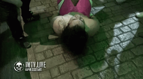 Woman In Pink And Green Outfit Laying On Ground Jwtv Live GIF