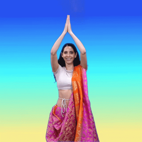 Woman in Pink and Orange Sari Hands Together
