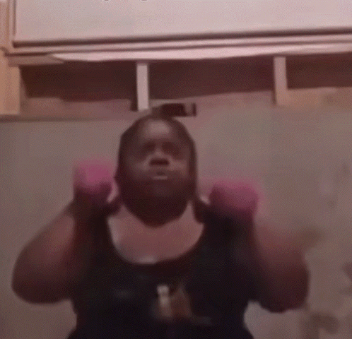 Woman in Pink Boxing Gloves Lifting Weights