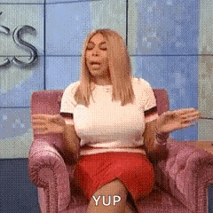 Woman in Pink Chair Hands Outstretched Yup