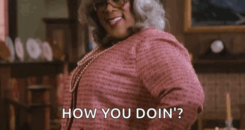 Woman in Pink Dress and Glasses Asking How You Doin