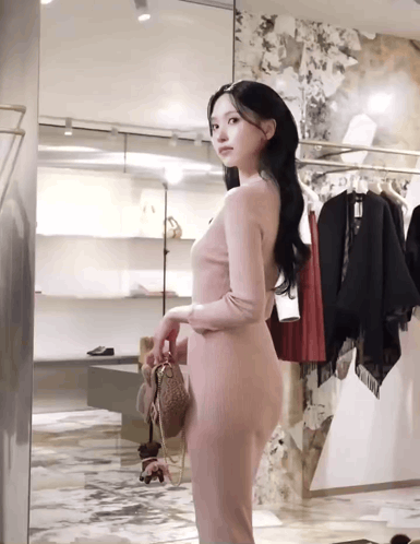 Woman in Pink Dress at Store Mirror