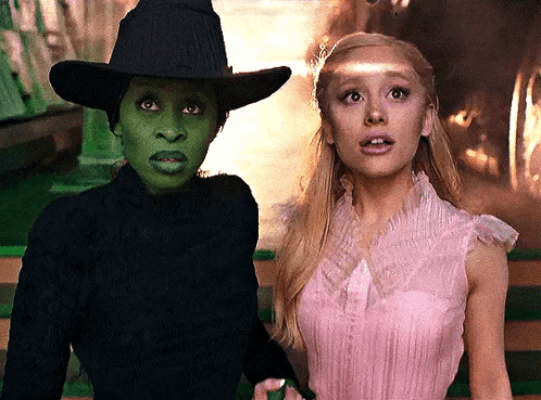Woman In Pink Dress Beside Woman In Black Hat GIF