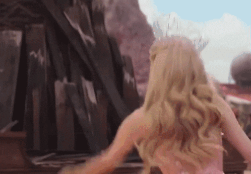 Woman In Pink Dress By Wooden Fence GIF