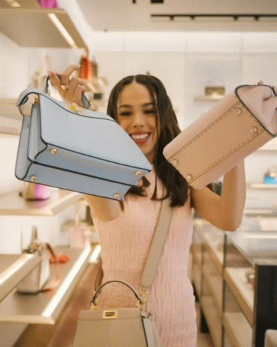 Woman in Pink Dress Holding Blue and Pink Purses