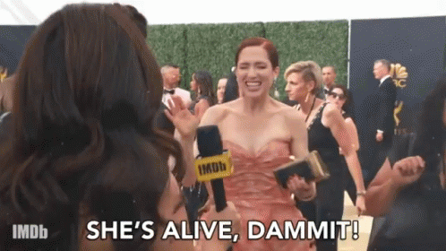 Woman in Pink Dress Holding Microphone on Red Carpet