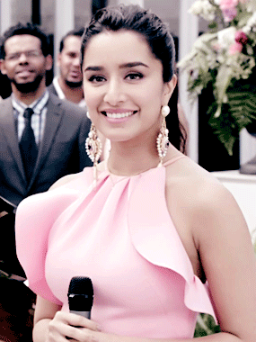 Woman in Pink Dress Holding Microphone Smiling