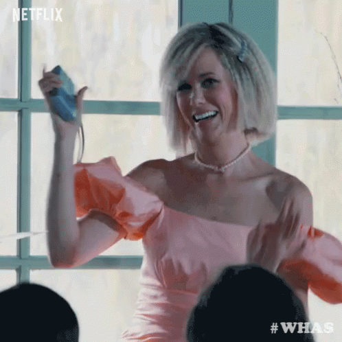 Woman in Pink Dress Holding Nintendo Wii