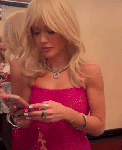 Woman in Pink Dress Looking at Cell Phone