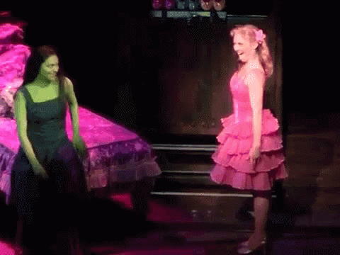 Woman In Pink Dress Next To Woman In Green GIF