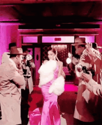 Woman in Pink Dress Photographed by Men