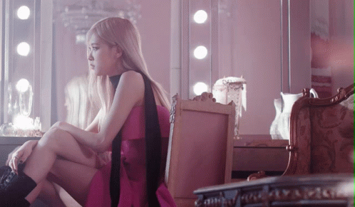 Woman in Pink Dress Sitting on Chair