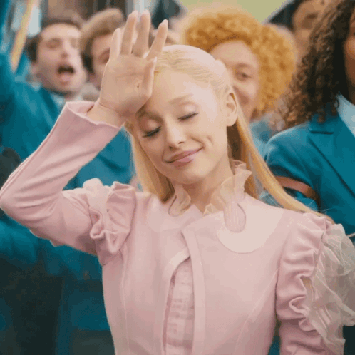 Woman In Pink Dress Smiling And Waving Hand GIF