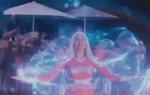 Woman in Pink Dress Surrounded by Glowing Umbrella