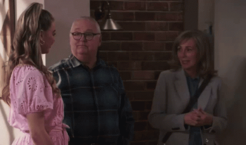 Woman in Pink Dress Talking to Man and Woman