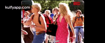 Woman In Pink Dress Talking To Man In Yellow Shirt GIF