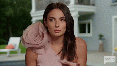 Woman in Pink Dress With Flower at House on Bravo