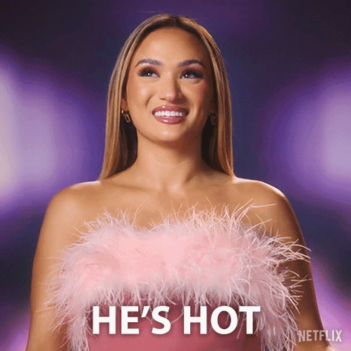 Woman in Pink Feathered Top Saying He's Hot