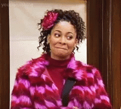 Woman In Pink Fur Coat And Flower Making Funny Face GIF