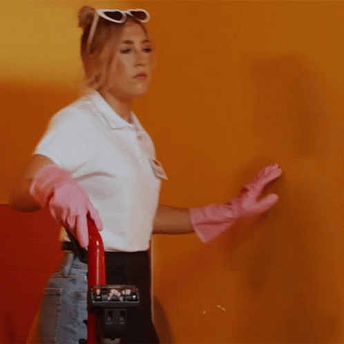 Woman in Pink Gloves Holding Vacuum