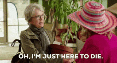 Woman in Pink Hat Holding Potted Plant Says Oh I'm Just Here To Die