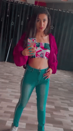 Woman in Pink Jacket and Blue Jeans Taking Selfie