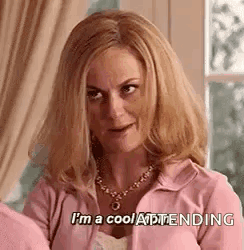 Woman in Pink Jacket and Necklace Says I'm a Cool Attendee
