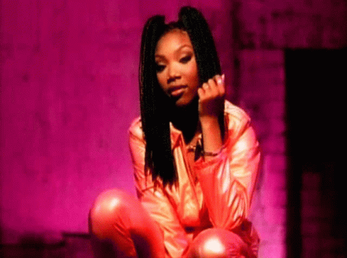Woman In Pink Jacket And Pants Kneeling GIF
