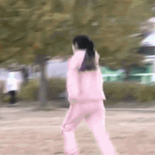 Woman in Pink Jacket and Pink Pants Walking in Park