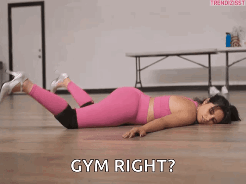 Woman In Pink Leggings Laying Next To Gym Right GIF