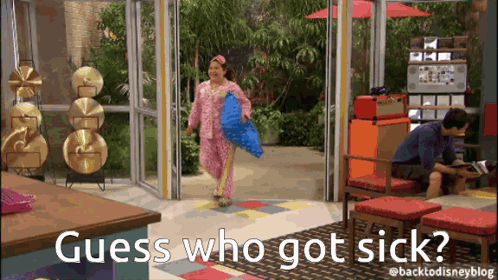 Woman in Pink Pajamas Holding Blue Pillow Man Behind