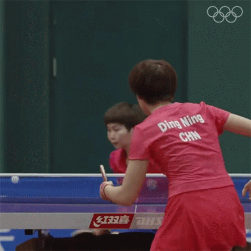 Woman in Pink Ping Pong Shirt Playing Ping Pong