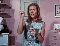 Woman in Pink Room Holding Wine