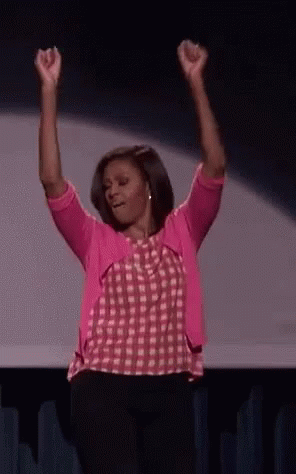 Woman in Pink Shirt and Cardigan Raising Arms