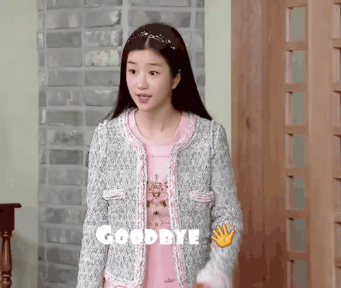 Woman in Pink Shirt and Grey Jacket Saying Goodbye