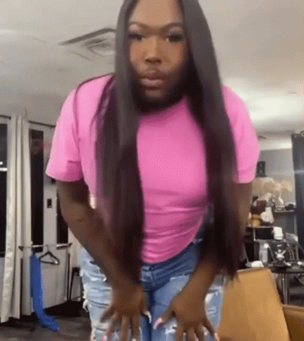 Woman In Pink Shirt And Jeans In Living Room GIF