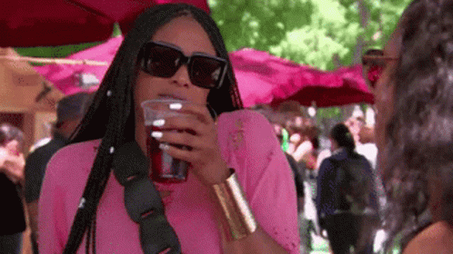 Woman in Pink Shirt Drinking