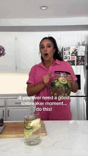 Woman In Pink Shirt Holding Lemon Cucumber Water Pitcher GIF