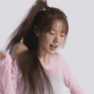 Woman in Pink Shirt Holding Ponytail Smiling