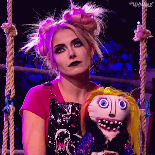 Woman In Pink Shirt Holding Stuffed Doll With Face GIF