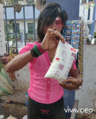 Woman in Pink Shirt Holding Vivavideo Bag